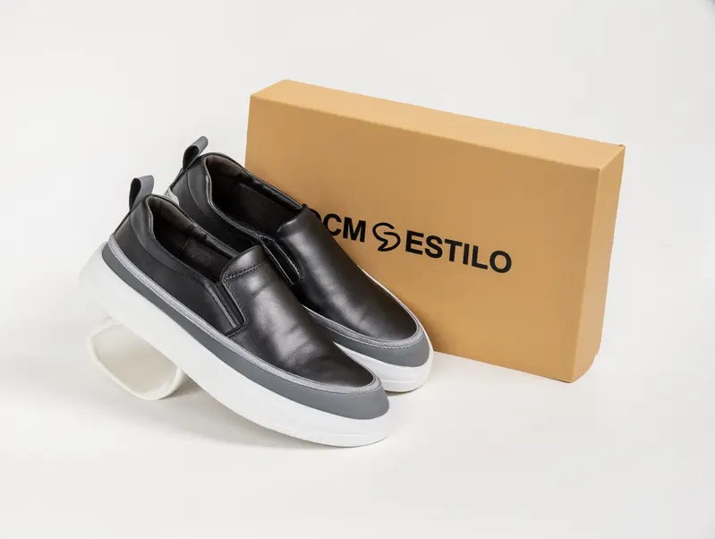 dcm-styles-black-shoes-next-to-a-cream-light-box-with-the-dcm-styles-logo